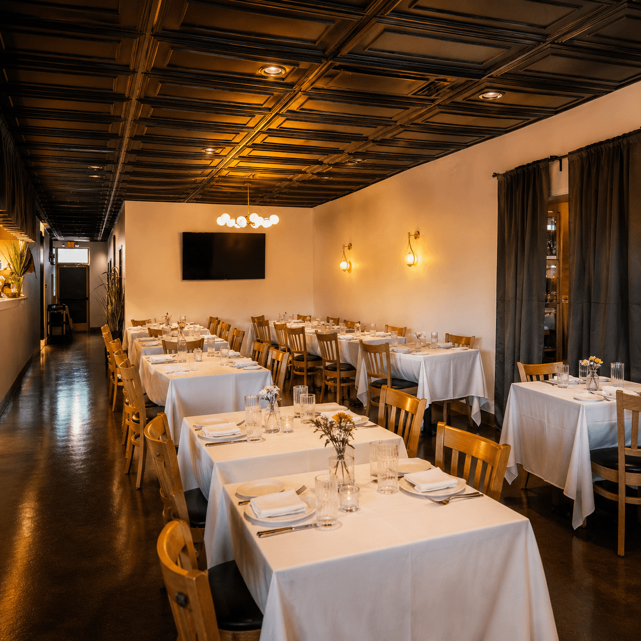 Chef Roma Henderson dining room arranged with white tablecloths for a group event